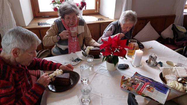 Eine Gruppe von Menschen sitzt um einen Tisch mit Essen